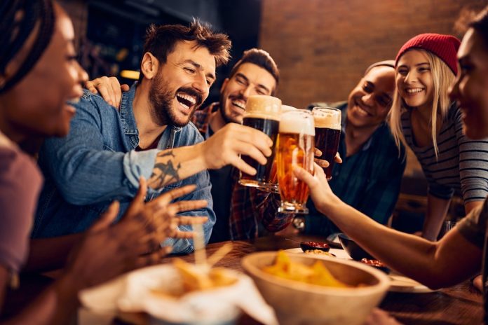 Multiracial,Group,Of,Happy,Friends,Having,Fun,While,Toasting,With