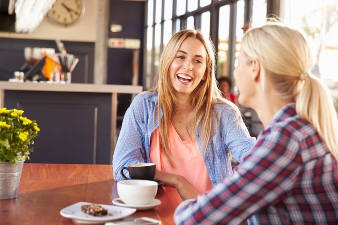 Two,Female,Friends,Talking,At,A,Coffee,Shop