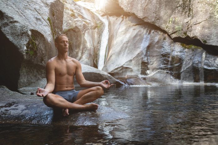 Young,Athletic,Boy,Doing,Iodine,And,Meditation,In,A,Waterfall