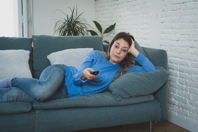 Bored,Woman,Watching,Tv,Helpless,In,Self,Isolation,At,Home
