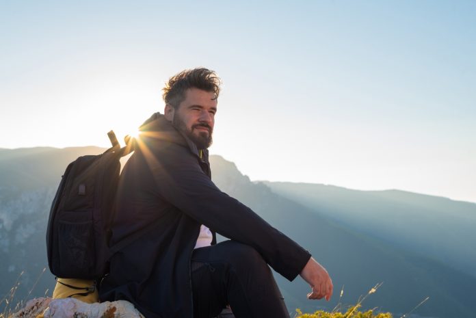 A,Man,Traveler,With,Backpack,Is,Relaxing,During,The,Hike