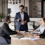Serious,Young,Business,Leader,Man,Holding,Meeting,With,Managers.,Colleagues