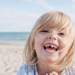 Little,Girl,With,Missing,Front,Tooth,Smiling